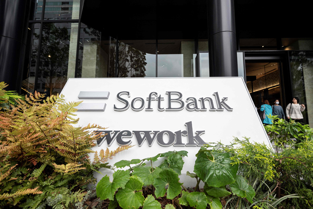 People walk out of the headquarters building for Japanese company SoftBank Group in Tokyo Portcity Takeshiba, on Thursday (AFP photo)