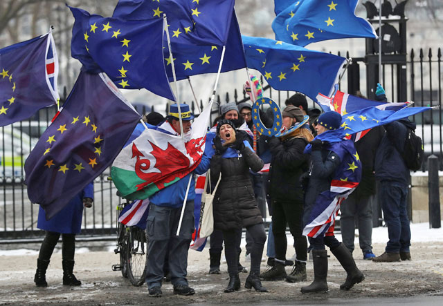 Anti-Brexit protesters wave flags outside Downing Street as European Council President Donald Tusk meets with Britain's Prime Minister Theresa May in London on Thursday  (Reuters photo)