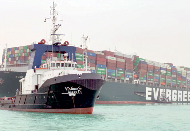 This photo, released on Wednesday, shows the Taiwan-owned MV Ever Given, a 400-metre long and 59-metre wide vessel, lodged sideways and impeding all traffic across the waterway of Egypt's Suez Canal (AFP photo)