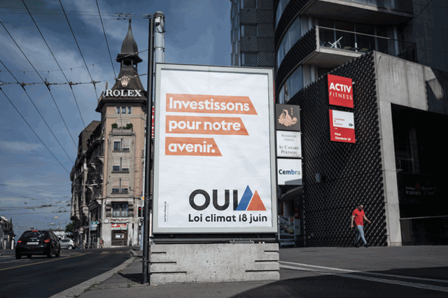 A photograph taken in Lausanne on Sunday shows an electoral poster reading in French 'Invest in our future, Yes, Climate Law June 18'. The Swiss, feeling the impact of global warming on their rapidly melting glaciers, were voting on Sunday on a new climate bill aimed at steering the country towards carbon neutrality by 2050 (AFP photo)