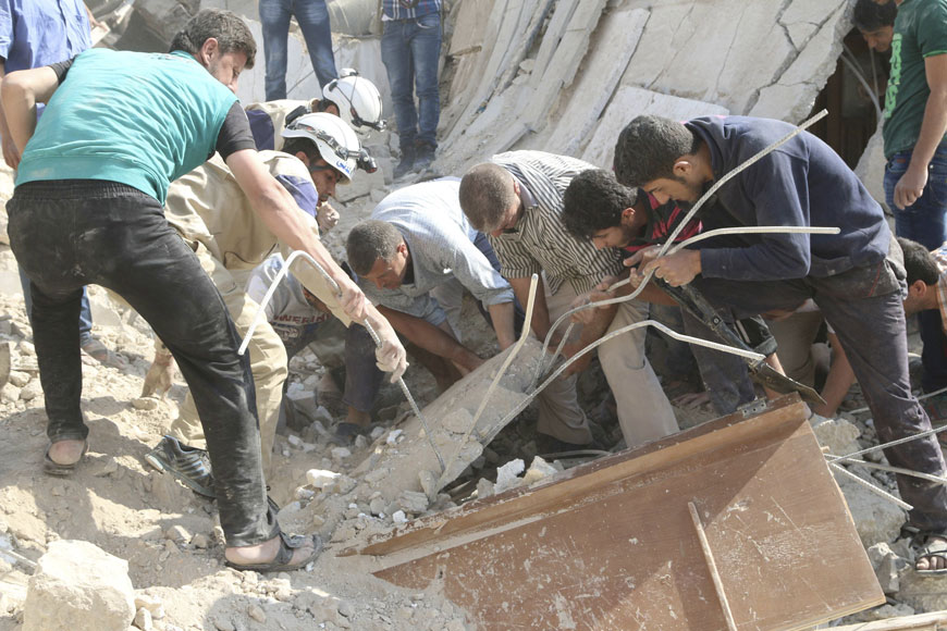 Civilians and civil defence members search for survivors under the rubble at a site hit by what activists said was a barrel bomb dropped by forces loyal to Syria's President Bashar Assad in the old city of Aleppo on Saturday (Reuters photo)