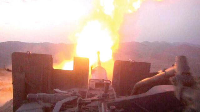 A photo released by the media office of Lebanon’s Shiite group Hizbollah on Sunday shows an artillery gun firing towards militants’ position in Jurud Arsal, a mountainous region bordering with Syria (AFP photo)