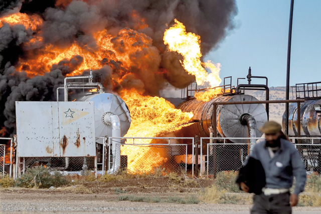 Fire raging at the Zarba oil facility in Qahtaniyeh in northeastern Syria, near the Turkish border after air raids (AFP photo)