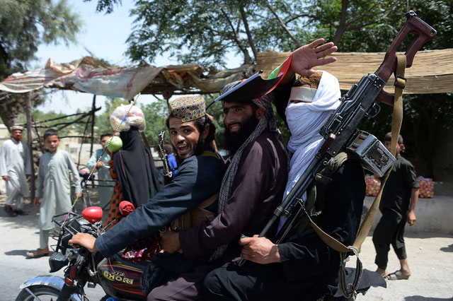 In this photo taken on June 16, 2018, Afghan Taliban militants ride a motorbike as they took to the street to celebrate ceasefire on the second day of Eid in the outskirts of Jalalabad (AFP file photo)