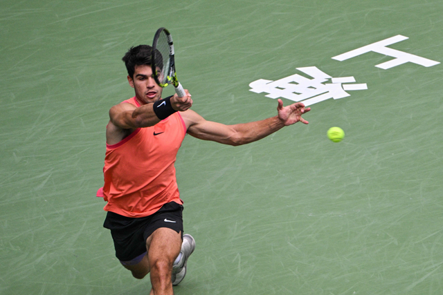 Spain's Carlos Alcaraz hits a return to France's Gael Monfils during their men's singles match at the Shanghai Masters tennis tournament in Shanghai on Wednesday (AFP photo)