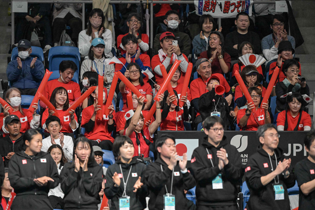 Japanese fans cheer on Japan's Ena Shibahara as she plays against Romania's Miriam Bianca Bulgaru during the first women's singles match between Canada and Romania in Tokyo on Saturday (AFP photo)