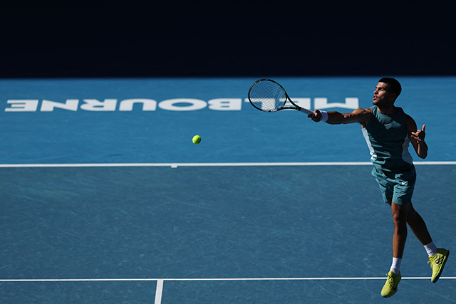 Spain's Carlos Alcaraz hits a return against Portugal’s Nuno Borges during their men's singles match on day six of the Australian Open tennis tournament in Melbourne on Friday (AFP photo)