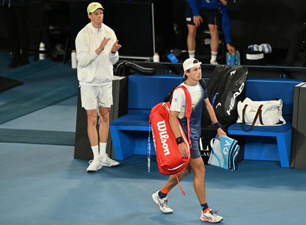 Australia's Alex De Minaur (right) leaves as Italy's Jannik Sinner applauds after their men's singles quarter-final match on day eleven of the Australian Open tennis tournament in Melbourne on Wednesday (AFP photo)
