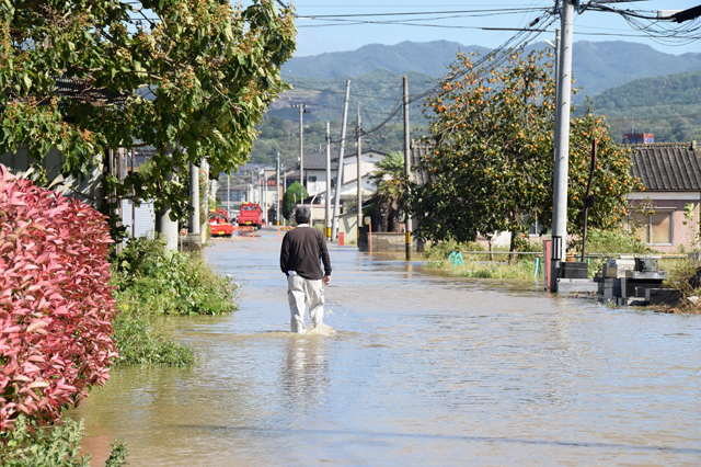A resident walks on a flooded road in Date, Fukushima prefecture on Sunday, one day after Typhoon Hagibis swept through central and eastern Japan (AFP photo)  
