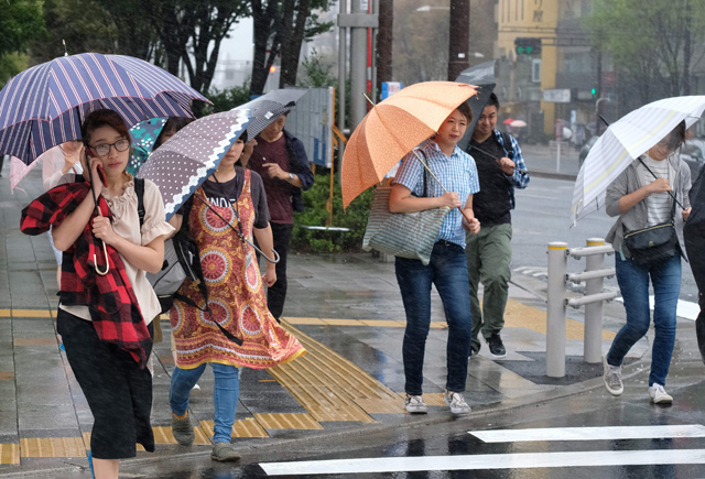 Pedestrians holding umbrellas walk in the rain in Tokyo on Wednesday  (AFP photo)