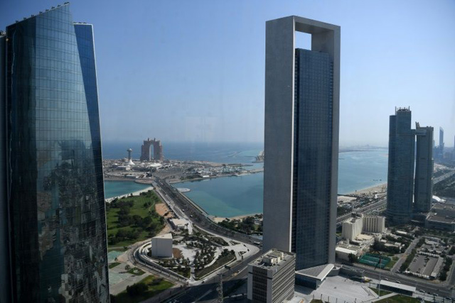 Sea front promenade in the Emirati capital Abu Dhabi with the ADNOC headquarters (Abu Dhabi National Oil Company) office complex (centre) in the foreground  (AFP photo)
