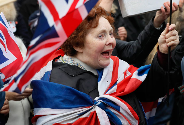 In this November  23 photo, ‘Brexit’ supporters wave flags outside parliament in London. Britons voted in June to leave the European Union, triggering financial and political upheaval (AP photo)