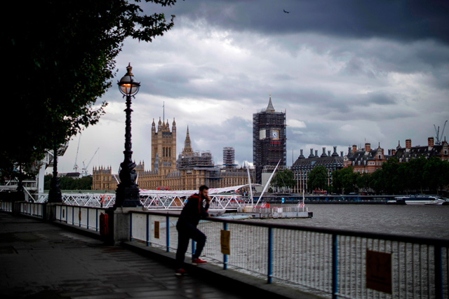 A man enjoys the view from Southbank of the River Thames and Palace of Westminster in central London on Monday (AFP photo)