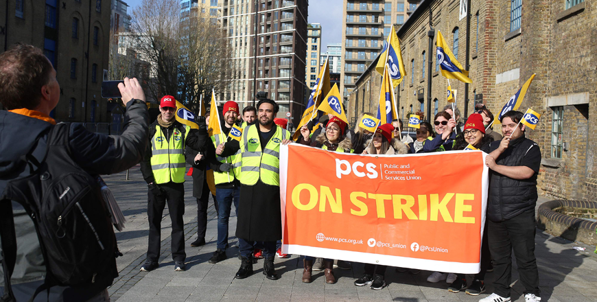 Members of the Public and Commercial Services union stand on a picket line on the first day of a five-week strike by UK passport office workers, in London, on Monday (AFP photo)