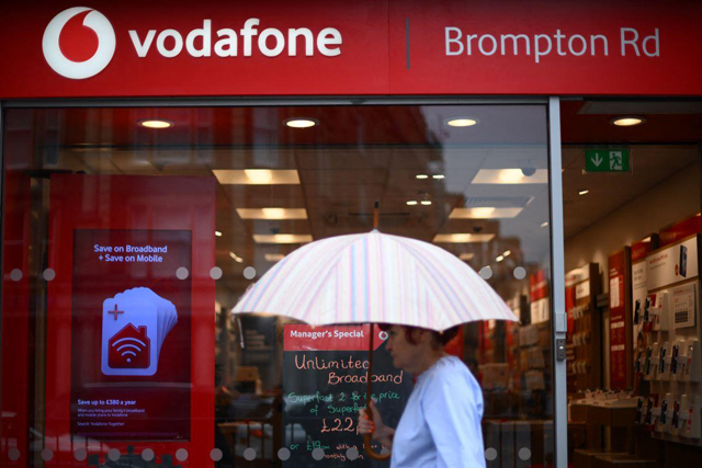 A pedestrian passes a Vodafone store in west London (AFP file photo)