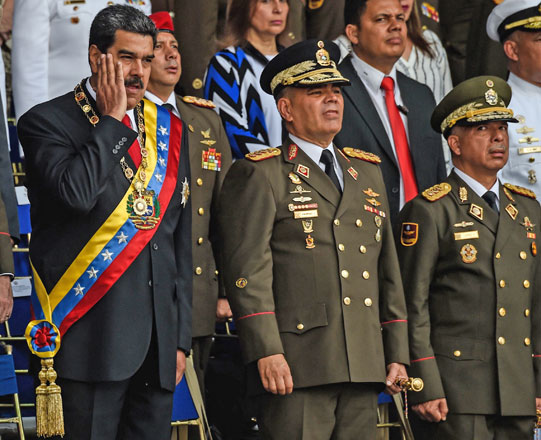 Venezuelan President Nicolas Maduro (left) gestures next to Minister of Defence General Vladimir Padrino (center), during a ceremony to celebrate the 81st anniversary of the National Guard in Caracas, on Thursday (AFP photo)