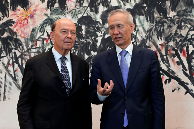 US Commerce Secretary Wilbur Ross (left) chats with Chinese Vice Premier Liu He during a photograph session after their meeting at the Diaoyutai State Guesthouse in Beijing, China, on Sunday (Reuters photo)
