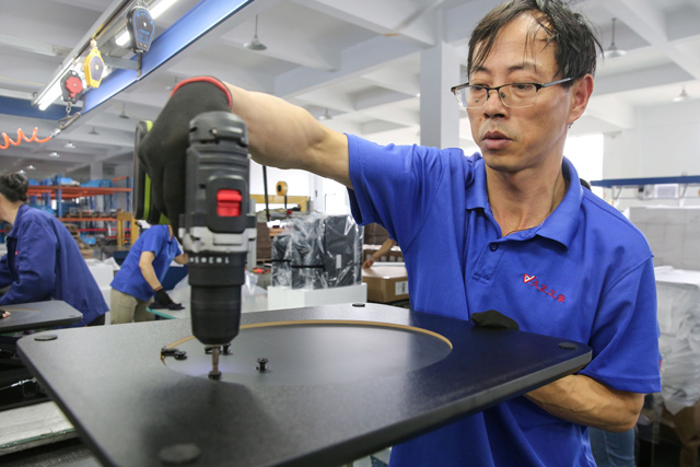 In this photo taken on Wednesday, a worker produces desks for export to the US, France, Germany and other countries, at a factory in Nantong in China's eastern Jiangsu province (AFP file photo)