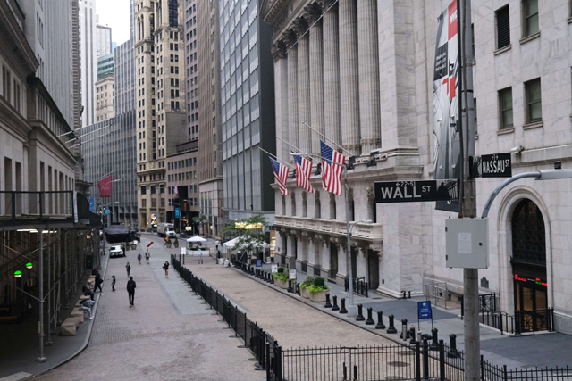 People walk by the New York Stock Exchange in lower Manhattan, on Friday (AFP photo)