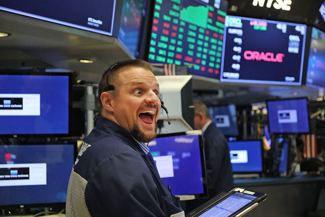 Traders work on the floor of the New York Stock Exchange on Tuesday in New York City. After ending lower the previous trading sessions, the Dow Jones industrial average rallied 2.17 per cent, or nearly 550 points (AFP photo)