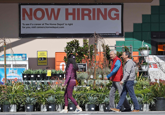 Home Depot customers walk by a posted now hiring sign on March 8 in San Rafael, California (AFP photo)