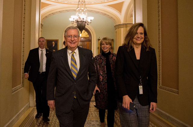 Senate Majority Leader Mitch McConnell (right-Kentucky) leaves from the Senate floor on capital hill on Saturday in Washington, DC (AFP photo)