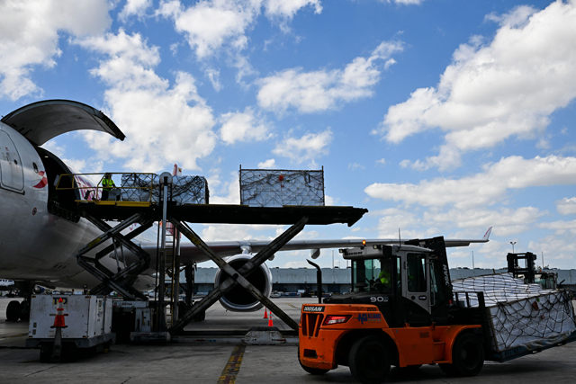Avianca Cargo employees unload flower crates from a cargo plane at the Miami International Airport in Miami, Florida, on February 12 (AFP photo)
