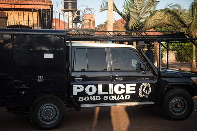A car of the Ugandan policeís bomb squad team is seen at a crime scene following a bomblast last night in Kampala, on Sunday (AFP photo)