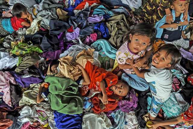Children play on donated clothing at a relief centre after being evacuated from Sebesi Island in Kalianda in Lampung province on Thursday, following the December 22 tsunami which hit the west coast of Indonesia's Java island  (AFP photo)