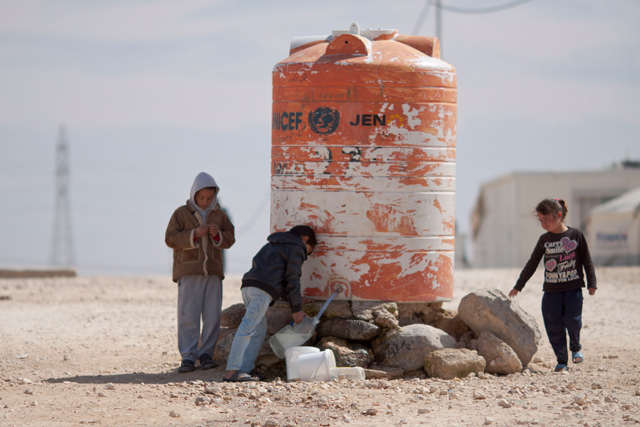 In this undated photo, children are seen filling up water from a tank at the Zaatari camp in Mafraq (File photo)