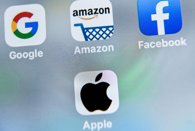 This photo, taken on August 28, 2019, shows the US multinational technology and Internet-related services company Google logo (top left), US online store application Amazon (top centre), US online social media and social networking service, Facebook (top right) and US multinational technology company Apple logo application (down centre) displayed on a tablet in Lille (AFP file photo)