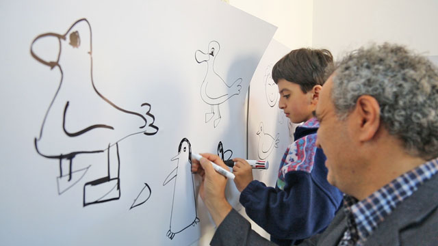 Cartoonist Emad Hajjaj teaches autistic children drawing at a workshop organised by the Society for the Care of Gifted Autistic Children in Amman on Tuesday (Photo courtesy of Autismjo)