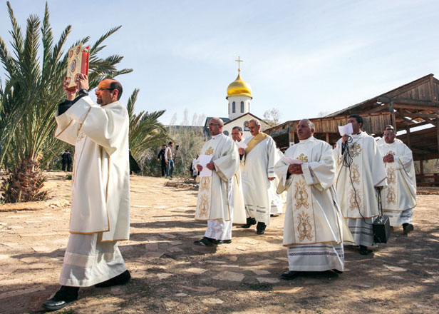 Roman Catholic clergymen and pilgrims gather at the Baptism Site of Al Maghtas, where Jesus is believed by Christians to have been baptised by John the Baptist, in the Jordan River Valley, on Friday. Hundreds of Catholic Christians also attended a special mass on the Jordanian side of the Jordan River in an annual pilgrimage to the site  (AFP photo)
