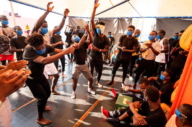 Migrants from eastern Africa dance onboard the Sea-Watch 4 civil sea rescue ship, that is waiting for permission to run into a port, on sea between Malta and Italy, on Sunday   (AFP photo)