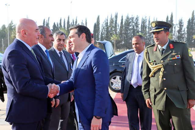 Minister of State for Investment Affairs Muhannad Shehadeh shakes hands with the Greek Prime Minister Alexis Tsipras on Sunday. The Greek prime minister was arriving for a trilateral summit with Jordan and Cyprus (Petra photo)