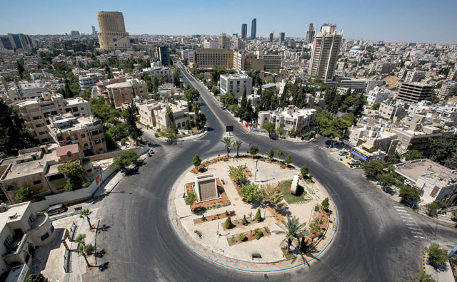 This photo taken on Friday shows a view of an empty roundabout during a COVID-19 coronavirus pandemic curfew in the centre of Amman  (AFP photo by Khalil Mazraawi)