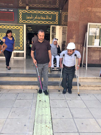A visually-impaired man walks along the USAID-funded safe walking lane at the University of Jordan in this undated photo (Photo courtesy of Hadeel Abu Soufeh)