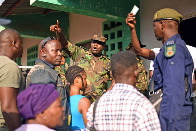 A military member shouts to keep order as people queue to cast their vote during Sierra Leone’s general election in Freetown, Sierra Leone, on Wednesday (Reuters photo)