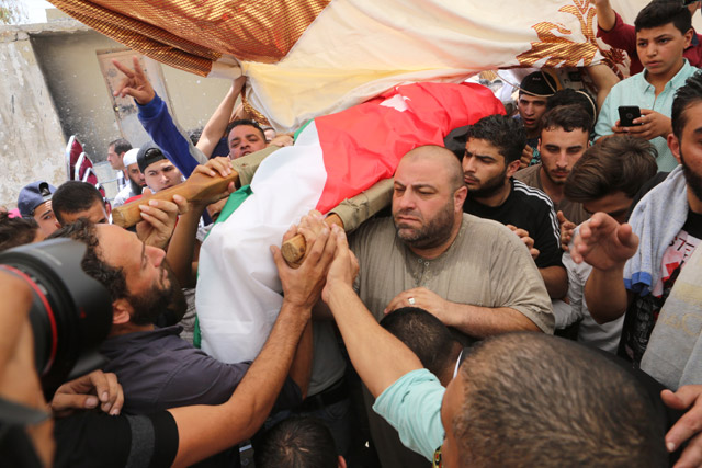 Mourners on Tuesday attend the funeral of 16-year-old Mohammad Jawawdeh who was shot dead by an Israeli embassy staffer in Amman, on Sunday (Photo by Raad Adayleh)