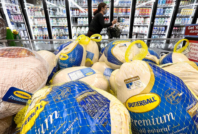 A shopper walks past turkeys displayed for sale in a grocery store ahead of the Thanksgiving holiday in Los Angeles, California, as prices across the US rose by 5 per cent last month compared to October 2020 (AFP file photo)