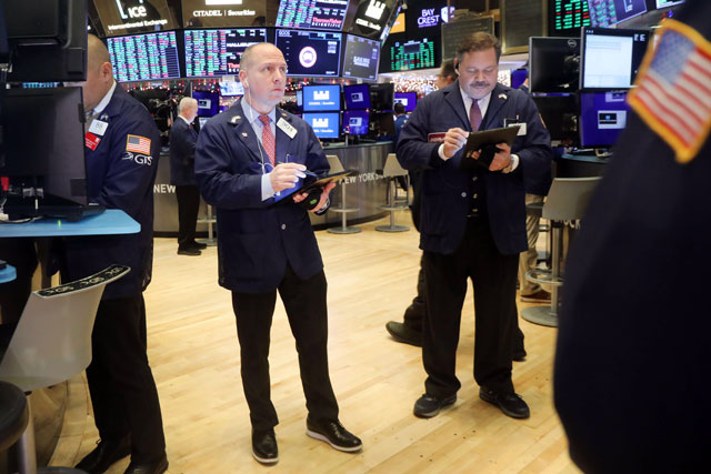Traders work on the floor of the New York Stock Exchange during the beginning of the Christmas holiday week, on Monday, in New York City (AFP photo)
