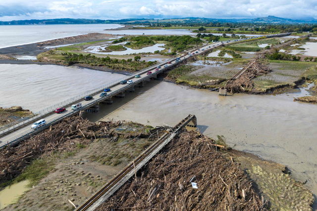 An aerial photo shows a rail bridge (right) damaged and washed away during Cyclone Gabrielle near Napier on Thursday. New Zealand is under a national state of emergency after Cyclone Gabrielle bore down on its northern coast, on February 12 (AFP photo)