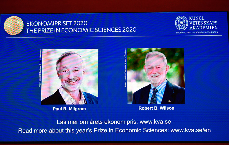 A screen shows photos of US economists Paul Milgrom (left) and Robert Wilson during the announcement of the winners of the ‘2020 Nobel Prize Sveriges Riksbank Prize in Economic Sciences in Memory of Alfred Nobel’ at the Royal Swedish Academy of Sciences in Stockholm, on Monday  (AFP photo)