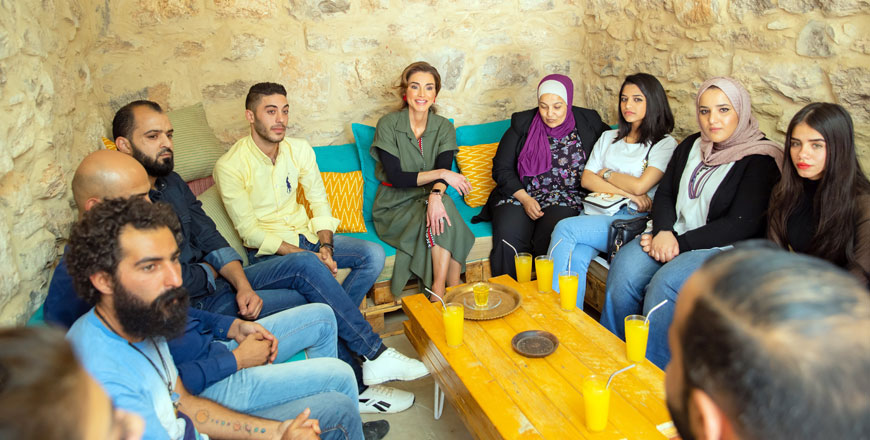 Her Majesty Queen Rania and youth at the Kawon bookshop in Madaba on Sunday  (Photos courtesy of Royal Court)
