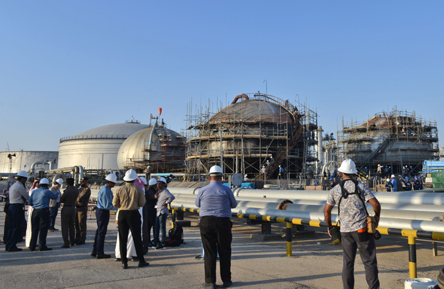 Journalists gather next to a damaged installation in Saudi Arabia's Abqaiq oil processing plant, on Friday (AFP photo)