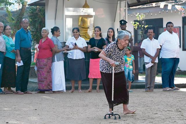 Voters queue up at a polling station to cast their ballots during the country's presidential election in Colombo on Saturday (AFP photo)