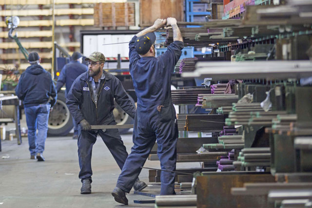 Labourers fill orders of machine grade steel to be shipped throughout the Pacific Northwest at the Pacific Machinery & Tool Steel Company in Portland, Oregon, on Tuesday  (AFP photo)