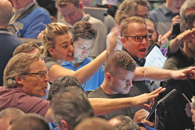 Traders signal offers in the S&P options pit at the Cboe Global Markets, Inc. exchange (previously referred to as CBOE Holdings, Inc.) on Tuesday in Chicago, Illinois (AFP photo)