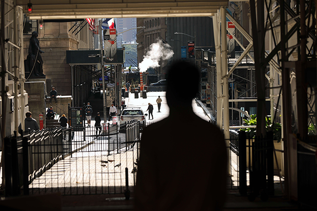 People walk in front of the New York Stock Exchange in lower Manhattan on Monday in New York City (AFP photo)