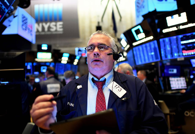 Traders work during the opening bell at the New York Stock Exchange, on Monday, on Wall Street in New York City (AFP photo)